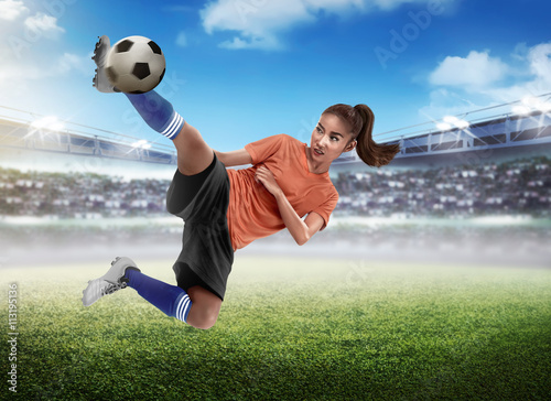 Asian woman football player kick ball