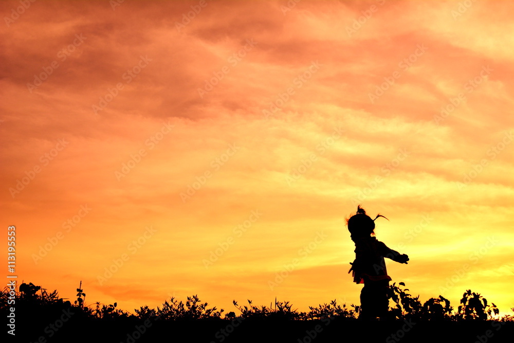 Silhouette little girl at sunset