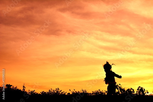 Silhouette little girl at sunset