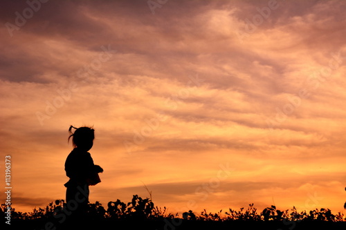 Silhouette little girl at sunset
