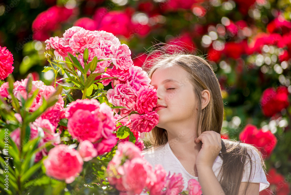 Beautiful girl standing in the park of roses. Beautiful girl standing in the park of roses.