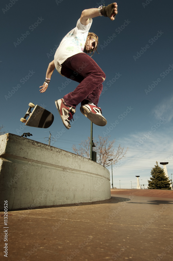 Young man jumping with skateboard Young man jumping with skateboard