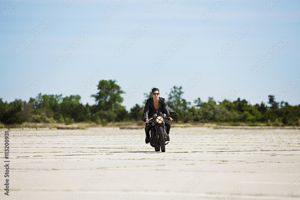 Portrait of man riding motorcycle at field against clear sky Portrait of man riding motorcycle at field against clear sky