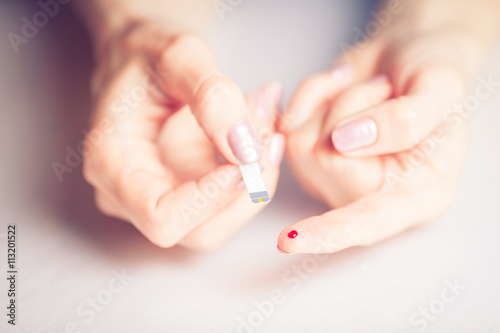 people concept - close up of female finger with blood drop and t