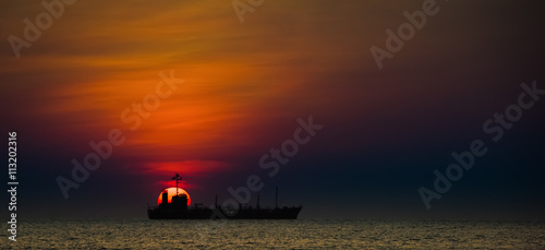 The big sun with ship at sunset, Rayong, Thailand