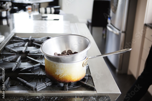 Chocolate chips in double boiler on stove