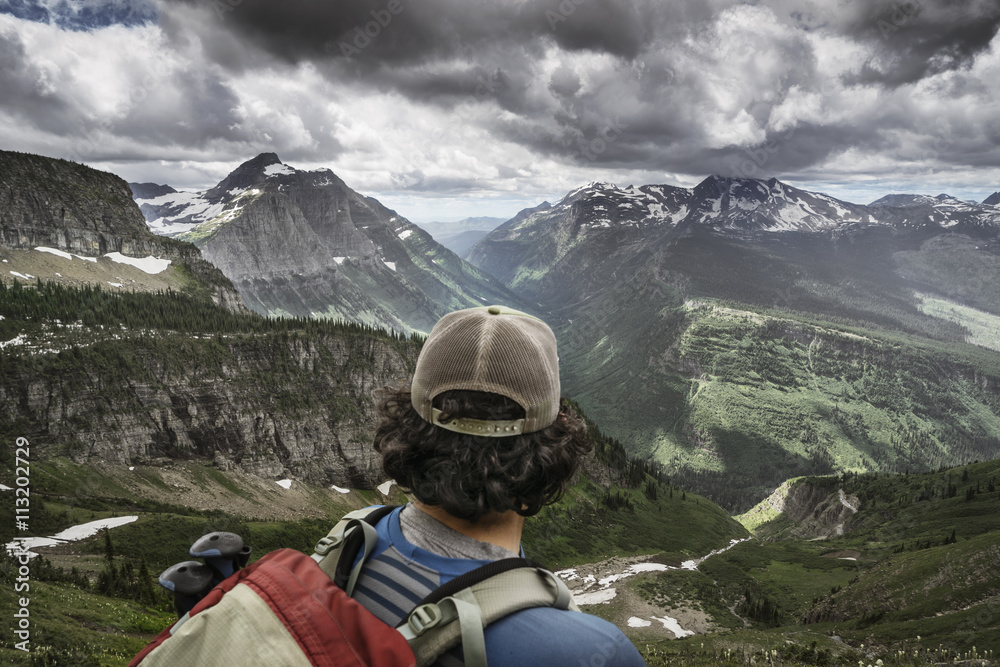 Rear view of hiker standing against mountain range Rear view of hiker standing against mountain range