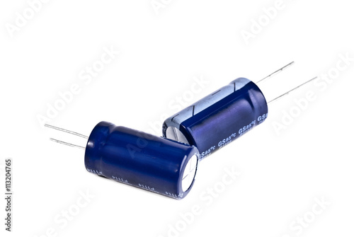 Two electrolytic capacitor in blue isolated on white photo