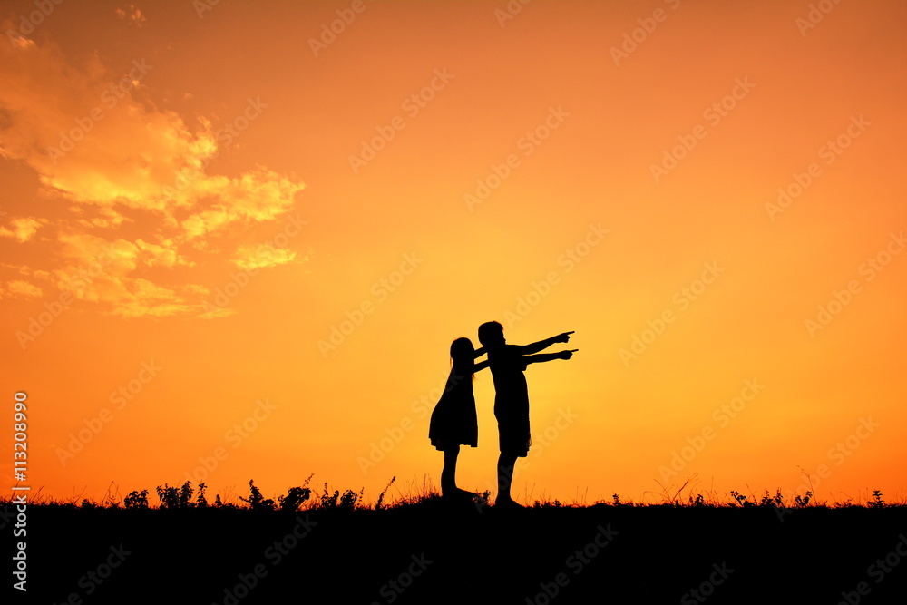 Silhouette children hands up in the sunset.Relax time Silhouette children hands up in the sunset.Relax time