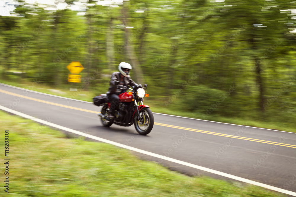 Man riding motor cycle on road Man riding motor cycle on road