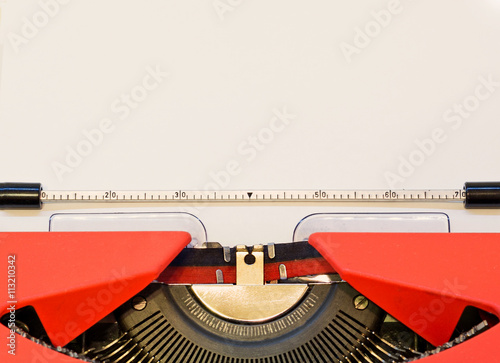 close up image of red typewriter with paper sheet. copy space for your text. retro filtered