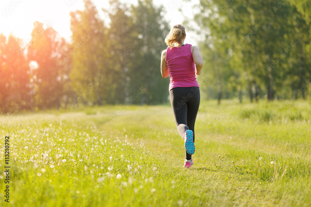 Young fitness woman running on the park. Marathon. Young fitness woman running on the park. Marathon.