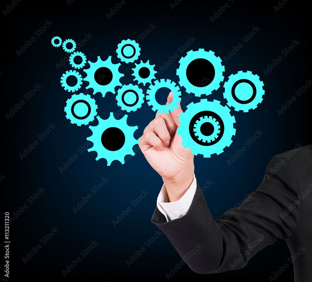 Businessman drawing gears on black background Businessman drawing gears on black background