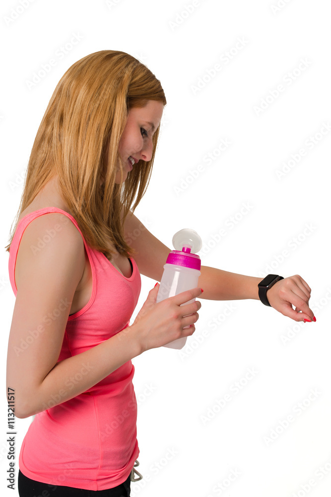 Young woman looking at digital watch with bottle in her hand Young woman looking at digital watch with bottle in her hand
