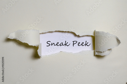 The word sneak peek appearing behind torn paper. photo