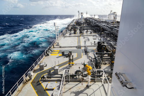 Big grey oil tanker underway in the open sea.