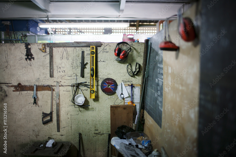 Tools and protective workwear hanging on wall Tools and protective workwear hanging on wall