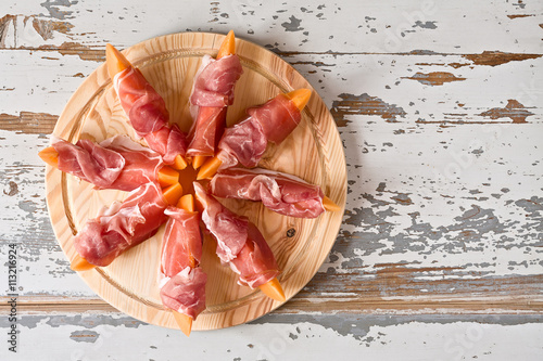 Italian food with prosciutto and melon