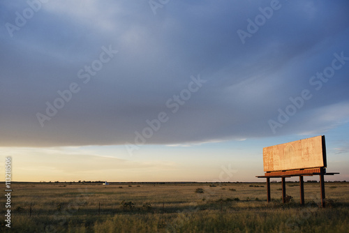 View of abandoned billboard in field