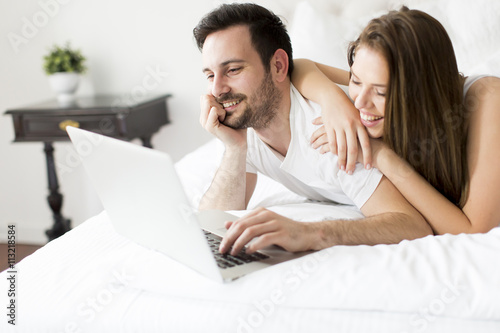 Young couple with laptop in...