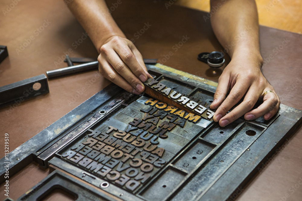 Close-up of woman working with letterpress Close-up of woman working with letterpress