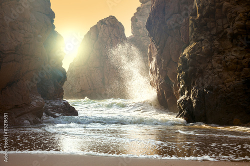 Fantastic big rocks and ocean waves at sundown time © Taiga