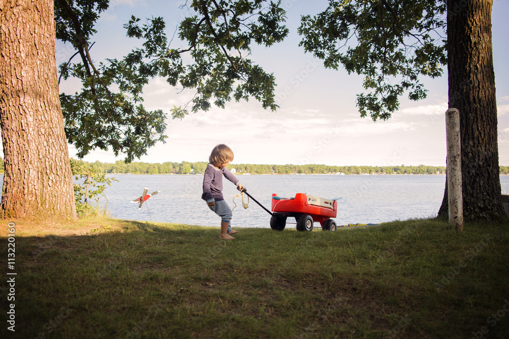 Boy playing by lake