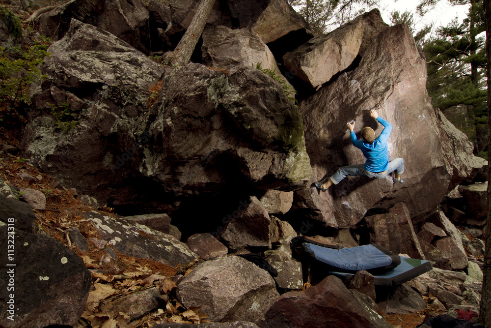 Rock climber practicing on small rock Rock climber practicing on small rock
