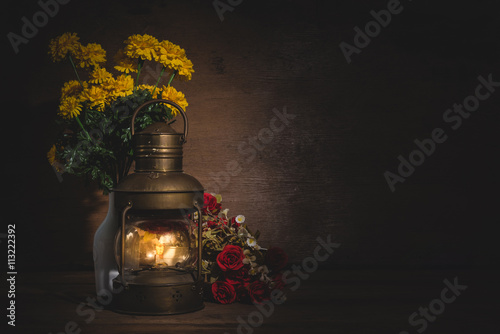Vintage kerosene lamp on wooden table over grunge background. still life