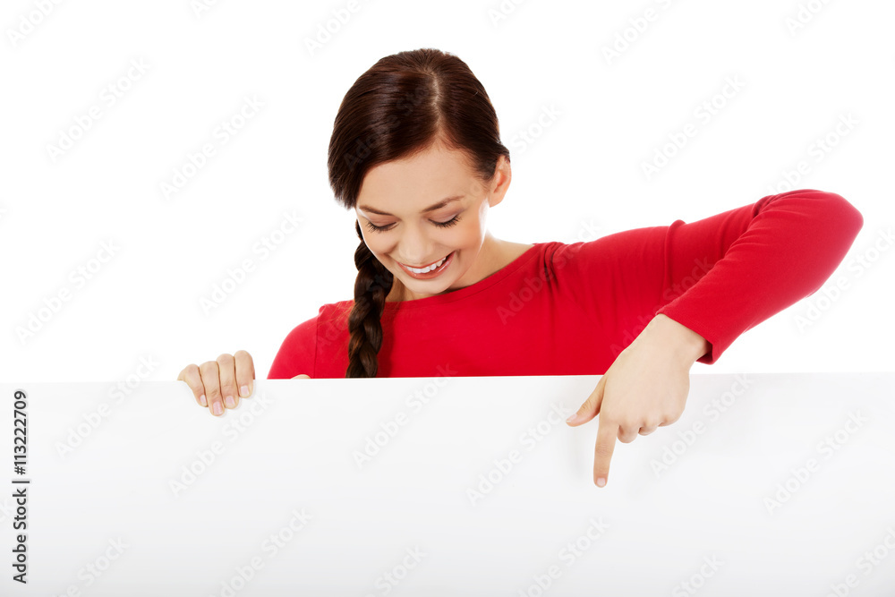 Beautiful student woman pointing on blank board Beautiful student woman pointing on blank board