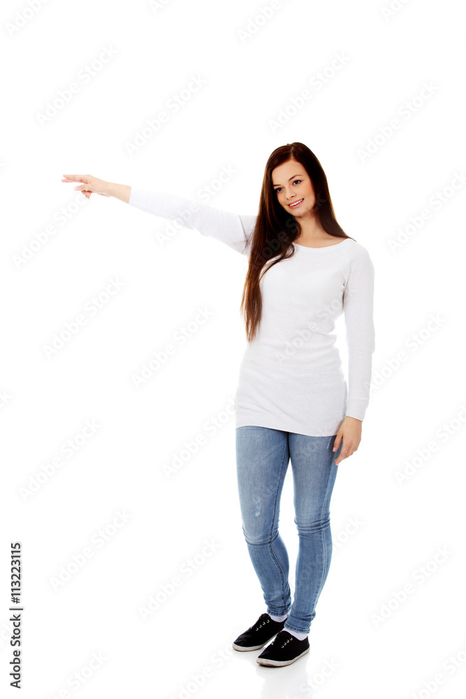 Smiling young woman shows something Smiling young woman shows something