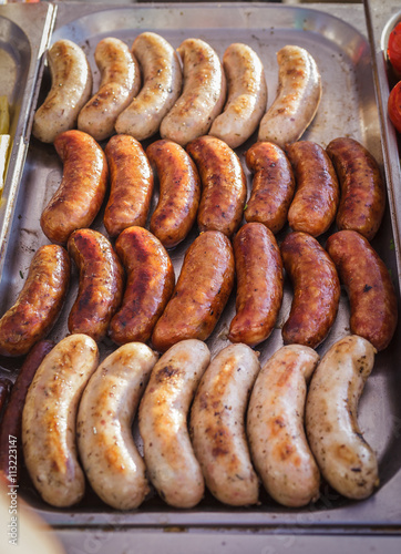 Sausages laid out on a baking sheet