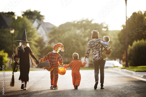 Rear view of a family dressed up in costume for Halloween