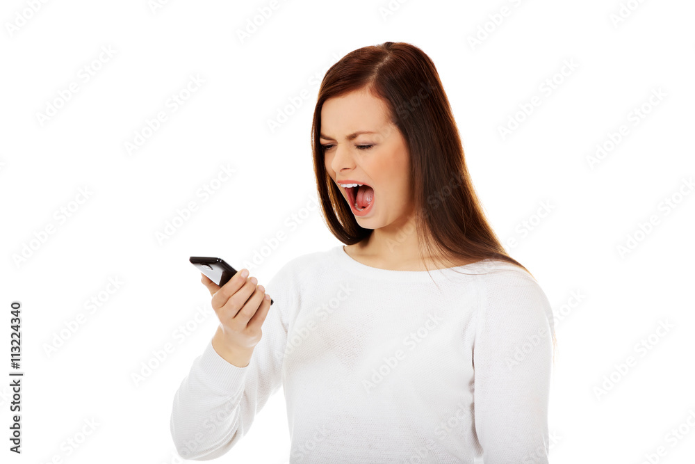 Young student woman yelling to the mobile phone Young student woman yelling to the mobile phone