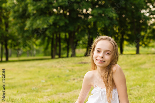 Outdoors portrait of beautiful young girl looking at you.