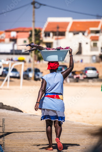 Woman carying fish on her head in Cape Verde, Africa