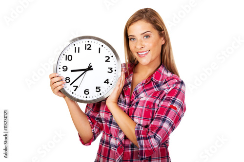 Young happy woman holding a clock