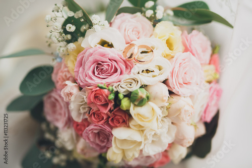 Pretty good wedding bouquet of various flowers with rings