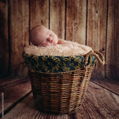 Cute Sleeping Newborn Baby In A Wooden Basket