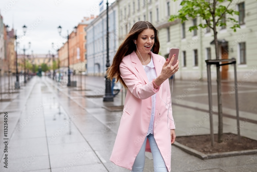 Modern woman in city texting cell phone