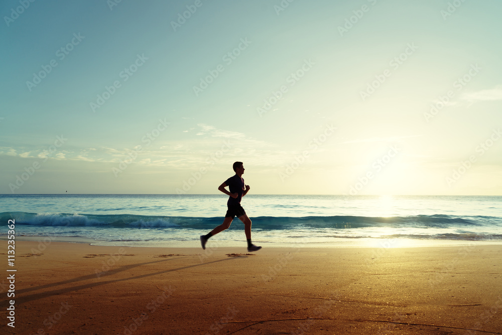Man running on tropical beach at sunset Man running on tropical beach at sunset