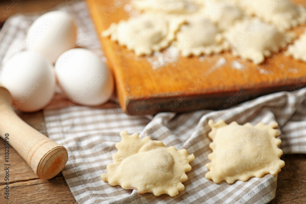 Uncooked ravioli on cutting board