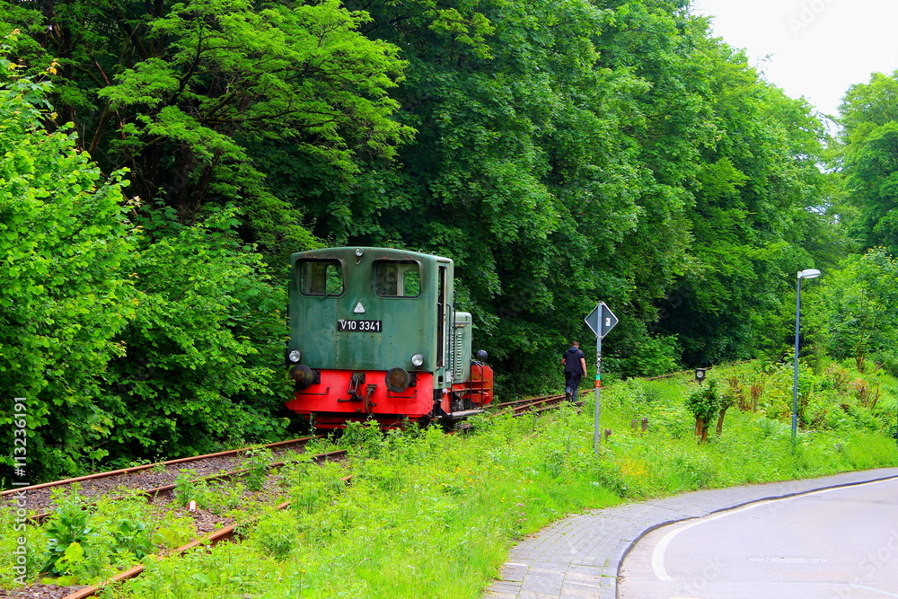 Naklejka premium A train and a railroad worker on a village railway