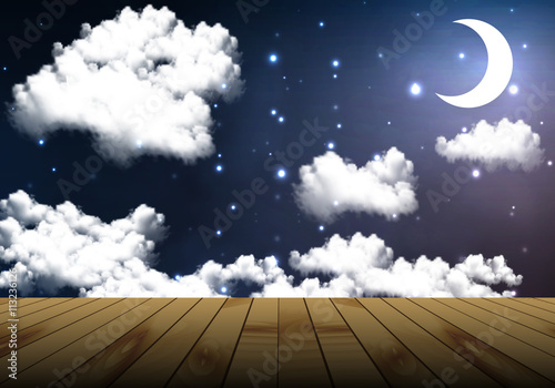 a wooden table on a background of the cloudy night sky