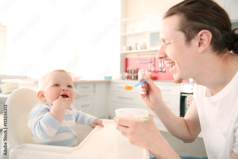 Father feeding his baby son Father feeding his baby son