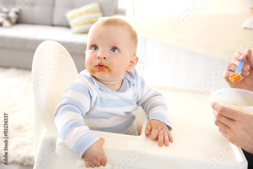 Little baby feeding with a ...