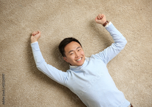 Handsome man lying on floor