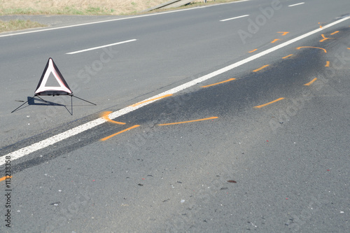 Warning triangle on the tarmac road after the car crash accident