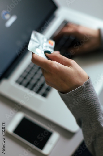 Person shopping making Payment at Computer using Credit Card