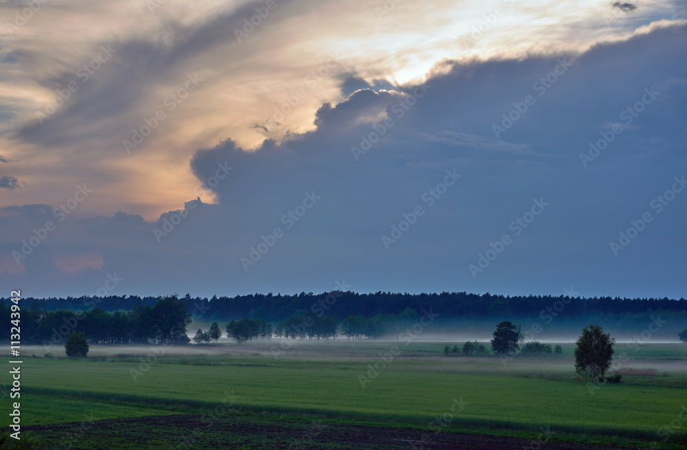 Village landscape with streaks of mist in Poland.